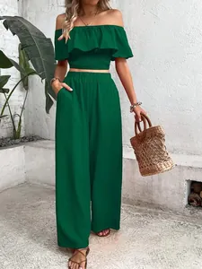 Detail of green two-piece set with off-the-shoulder smocked top and wide-leg pants