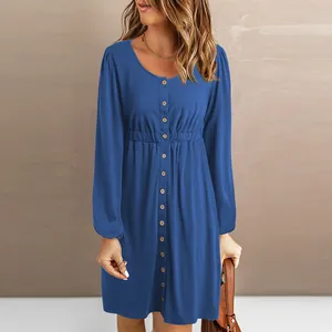 Detail shot of a casual blue long-sleeved button-front mini dress with cinched waist.