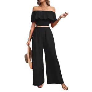 Elegant two-piece black off-shoulder ruffle crop top and wide-leg trousers set for women