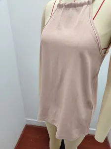 Dettaglio di un top a lupetto rosa chiaro con vestibilità morbida su un manichino sartoriale