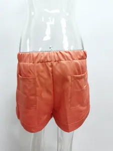 Detailed back view of orange casual high waist wide leg tencel shorts with pockets
