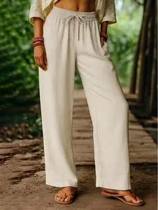 Detailed shot of beige cotton linen wide-leg trousers with an elastic drawstring waist