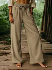 Close-up of khaki cotton linen wide-leg trousers featuring elastic drawstring waistline