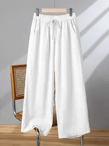 Macro view of white breathable cotton linen wide-leg trousers featuring elastic drawstring waist