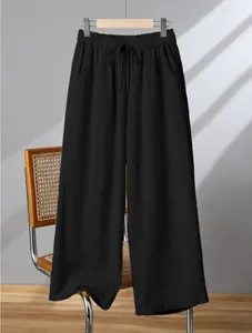 Macro detail of black cotton linen wide-leg pants with comfortable elastic drawstring waist