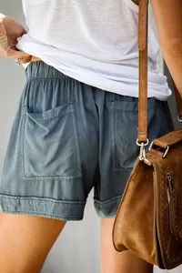 Detail of women's grey-blue casual shorts showing back pockets and elastic waistband