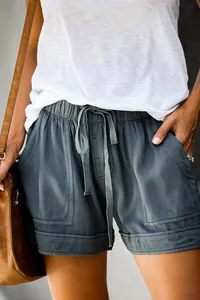 Detail view of women's dark grey high waist Tencel shorts with drawstring and pockets.