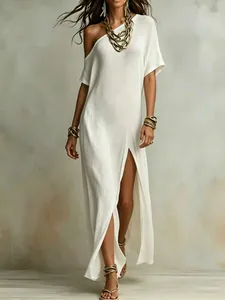 Elegant white cotton linen pleated dress with high slit and asymmetrical neckline.