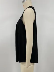 Side profile of a minimalist black sleeveless top with pleated chest detail on a mannequin