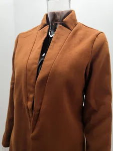 Detailed macro shot of a brown stand collar wool coat showing premium fabric texture