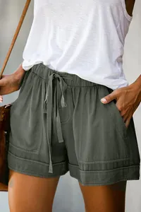 Close-up detail of women's high-waist drawstring casual shorts in olive green cotton