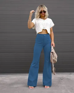 Fashionable blue high-waisted corduroy flare pants styled with a trendy white crop top.