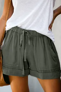 Detailed view of women's high-waisted drawstring shorts with large pockets in olive green