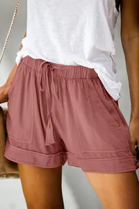Detail view of women's rose pink high-waisted shorts with drawstring and pockets.