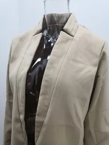 Detailed view of the standing collar and fabric texture on a beige woolen coat