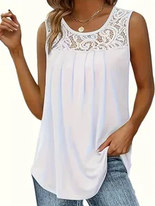 Detailed view of white sleeveless top featuring delicate lace yoke and elegant front pleats
