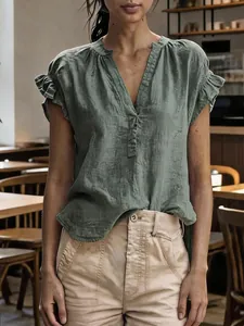 Detailed view of a sage green V-neck cotton linen top featuring ruffled short sleeves