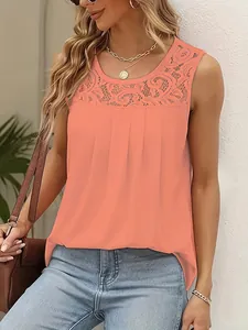 Detail view of peach sleeveless blouse featuring intricate lace neckline and pleated chest.