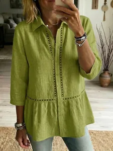 Detail of green cotton linen shirt featuring intricate eyelet lace trim and ruffles.