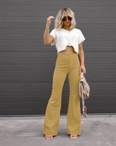 Full body view of stylish yellow high-waisted corduroy flare pants on a female model