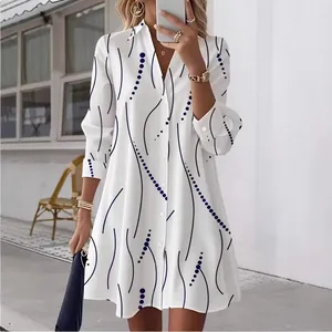 Elegant long-sleeved white shirt dress featuring a chic black wave and polka dot print