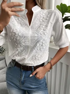 Elegant white V-neck stand collar blouse with floral embroidery and delicate lace details.