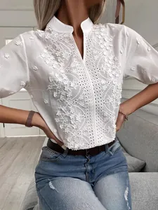 Elegant white V-neck stand collar blouse featuring delicate floral embroidery and lace details
