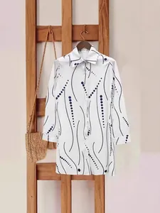 Elegant white long-sleeve shirt dress with black wavy lines and polka dot pattern for women.