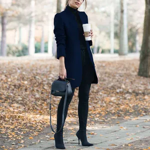 Full length view of a fashionable navy blue stand collar woolen coat in an autumn park