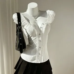 Close-up detail of white puff sleeve blouse with button-front design on a mannequin