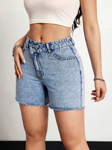 Close-up of high-waisted light wash denim shorts featuring a unique crossover waistband design.