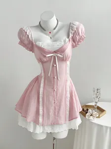 Elegant pink mini dress with bow-knot and contrast lace puff sleeves on mannequin.