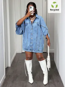 Detail view of a women's street fashion oversized light blue denim jacket with wide sleeves