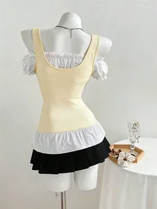 Back view of slim fit patchwork short-sleeve T-shirt with ruffled hem and black skirt