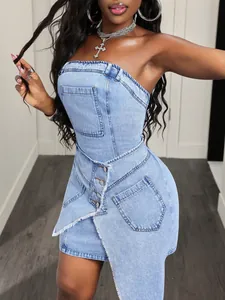 Detail of strapless denim mini dress with irregular button front and pocket design