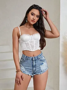 Detailed shot of trendy high waist light blue denim shorts with stylish frayed edges