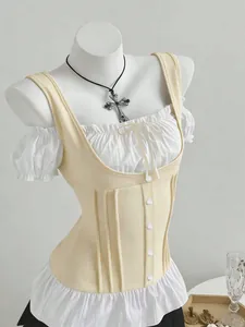 Detail view of puff sleeve white blouse with cream corset vest and bow knot detail