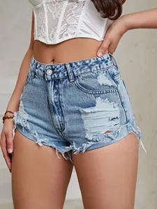 Close-up of high-waist distressed denim shorts with frayed edges