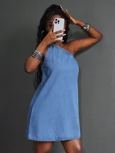 Detail view of a one-shoulder blue denim mini dress with a casual summer design.