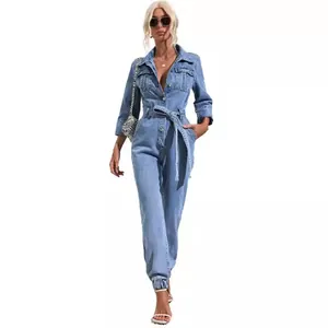 Caucasian model in a light blue long-sleeve denim jumpsuit with belt and chest pockets