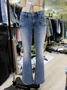 Detailed view of high-stretch blue flare jeans for women featuring a low waist and front pockets