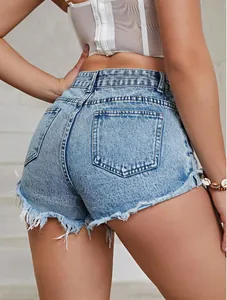 Detail view of high-waisted denim shorts with frayed raw hem and back pockets