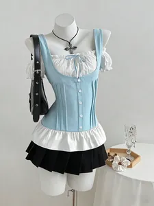 Close-up of a blue corset patchwork top and pleated skirt set on a white mannequin