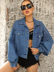 Detail view of a loose-fitting short denim jacket with puff sleeves