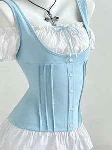 Detail view of a slim fit blue corset vest layered over a white ruffled top with a bow