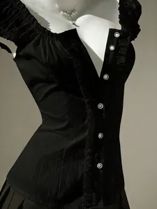 Close-up detail of a black sweet-style ruffled puff sleeve blouse with button-up design