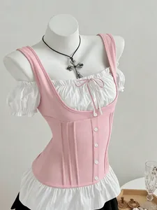 Detail view of pink corset-style stitching top with white puff sleeves and bow tie