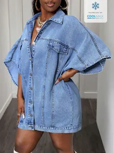 Detail of the light blue denim cape jacket with unique sleeve structure on a model.