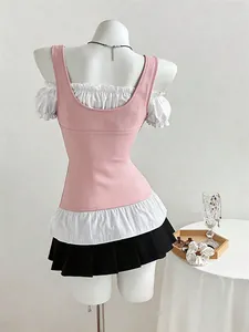 Back view of stylish pink and white ruffled patchwork top with black pleated skirt