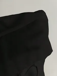 Macro view of black puff sleeve blouse showing the lightweight woven fabric texture